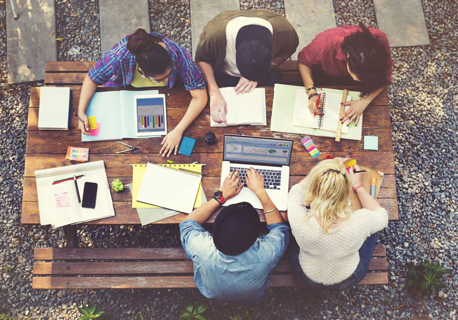 alma-mater-students-at-a-picnic-table-working-on-academic-tutoring